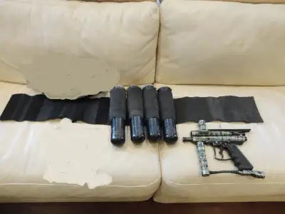 Selling some Paintball Equipment that includes ONE Genesis Surge Camo Shooter and a Belt Pod holder...