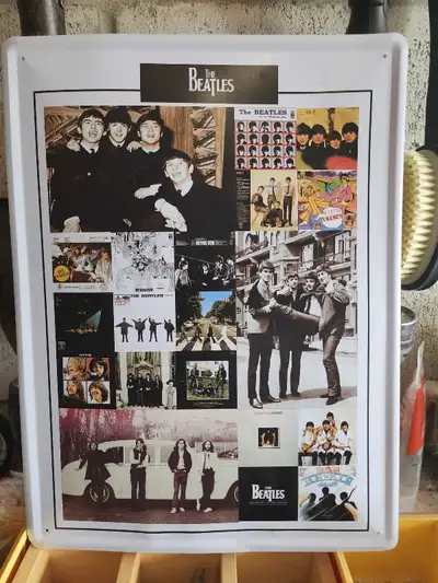 This vintage The Beatles metal sign showcases a collage of iconic imagery from the band's legendary...
