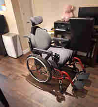 6 mth old wheelchair,red, 20 inc wide,18 deep,headrest.