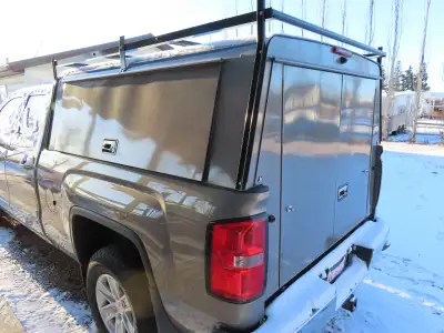 Tradesman topper shown sitting on a 2017 GMC Sierra with 6'7" box. Has been painted to match it's Pe...