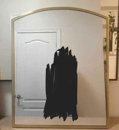Arched wall mirror featuring a sleek, brushed gold metal frame, View more