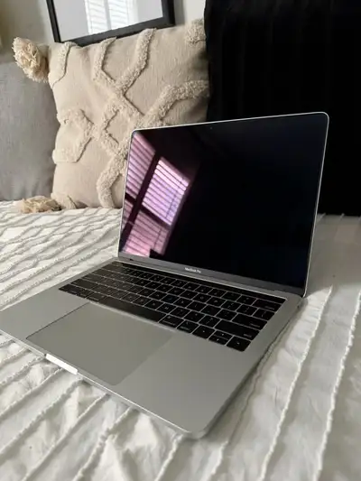 This sleek, space grey MacBook Pro is equipped with 256GB of storage and 8GB of RAM, making it perfe...