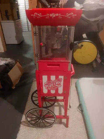 Popcorn machine 4 ft High just about 14x14 Square two pieces base with wheels and top only used a fe...