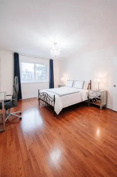 Cozy master bedroom with an attached private bathroom in a well-maintained detached house located in...