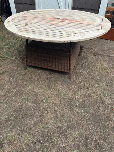 Large round outdoor patio dining table in good solid condition ready for a refinish Features a beaut...