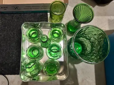 Vibrant green glass collection. Has 3 larger vases/glasses and 7 smaller candle holders. The tall va...