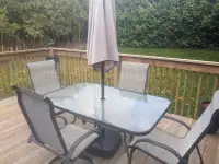 Patio set including chairs, table and umbrella 