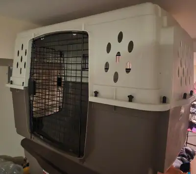 Large dog crate; lightly used. 7 inch L / 24 inch W / 26 inch H Two large doors plus wire window and...