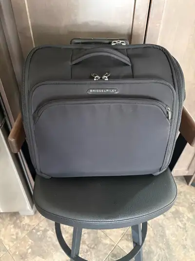 New Briggs and Riley carry on cabin roller. Description in pics. One pic looks like it has a mark bu...