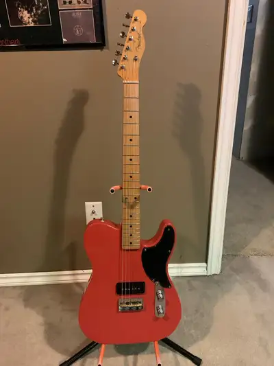 This Fender Noventa Telecaster features a striking red finish and a unique P90 pickup configuration...