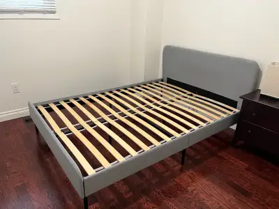 This is a Zinus full-size bed frame with a grey upholstered headboard. The bed frame is in used few...