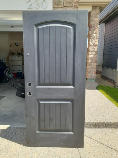 79"x36", pre-hung, includes 'peep hole' (1 year old). Black exterior, white interior (factory painte...