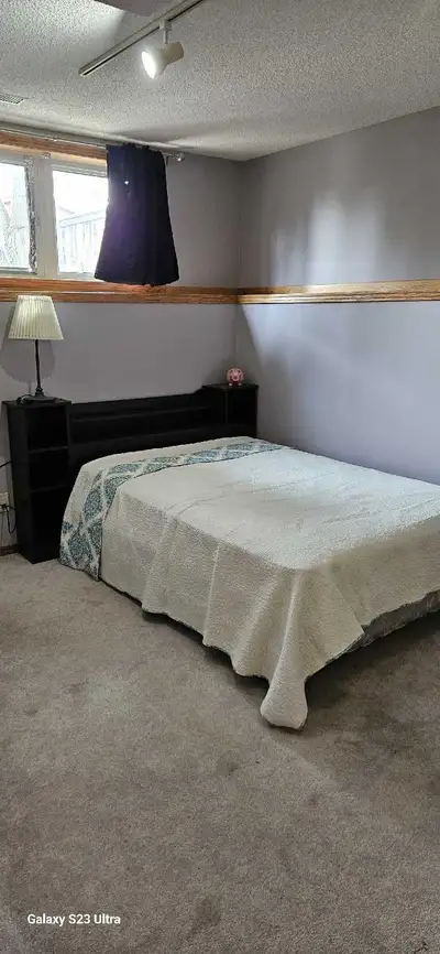 A spacious and clean single bedroom is available in a quiet basement suite of a bi-level house locat...
