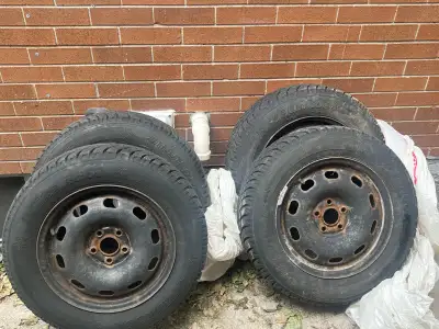 Selling four 15-inch black steel rims with Hankook winter tires. Bolt Pattern: 5x100 (Fits 1999–2006...