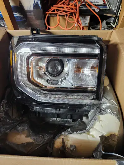 Brand new in box GM right headlight Never installed. GM part number 84568273