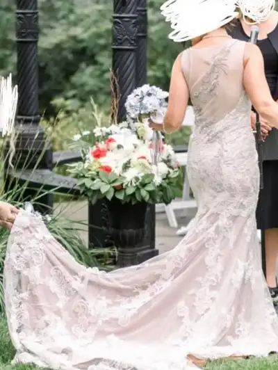 Champagne-coloured underneath with lace overlay. Beading details on back and straps. Seamstress has...