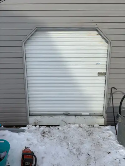 Roll up door for shed 6’wide 6’8”tall spring loaded. Rails included.