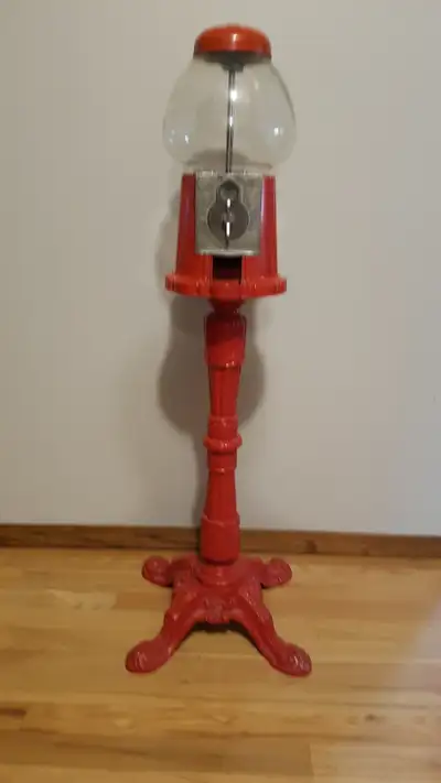 Vintage Cast Iron Gumball machine, coin operated. Includes base, stand and glass globe. $125