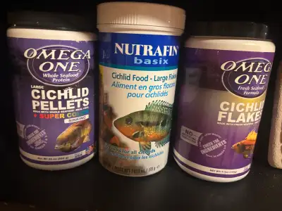 3 containers of cichlid fish food Both Omegas (flakes and pellets) are half full, the nutrafin flake...