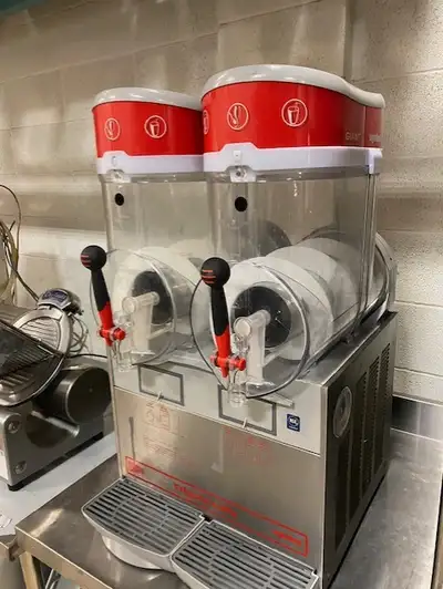 You are viewing a nicely used 2 Flavor Slush Frozen Beverage Machine. This Ugolini Giant Double Bowl...