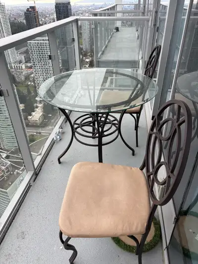 Glass table with two chairs, $80 for the set. The glass top is removable for easy transport. Chairs...