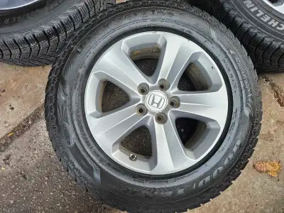 Selling 4 original 17 inches Honda odyssey rims and winter tires on them 235/65/R17. Rims and tires...