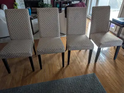 Modern fabric upholstered dining chairs. Black wood frame, beige, and off-white pattern for seat. Ch...