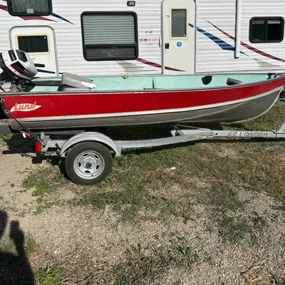 12 feet Lund fishing boat. Incl ez loader trailer. 5 hp Honda 4 stroke engine. Runs good. Gas can, 2...