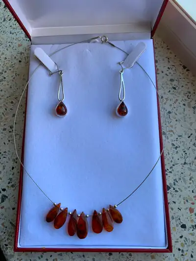 Selling Amber sterling silver necklace and sterling silver earrings. Never been used. Price for the...