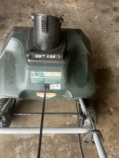 Yardworks 13A electric snow thrower. It has a 20-inch clearing width. This electric snow thrower is...
