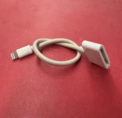 Collection of various legacy Apple cables and adapters, View more