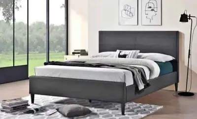 This is a used queen-size bed frame featuring a sleek, dark grey upholstered headboard and matching...