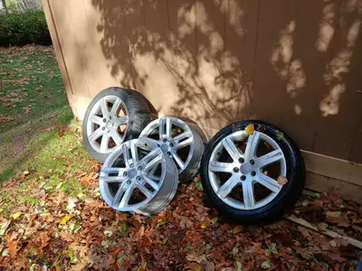 For sale is a set of used Audi A3 alloy rims, sized at 225/45R17, accompanied by two winter tires. T...