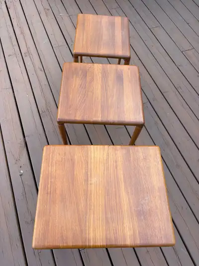: "Authentic vintage 1960s Scandinavian modern nesting tables. Beautiful rich teak wood grain, clean...