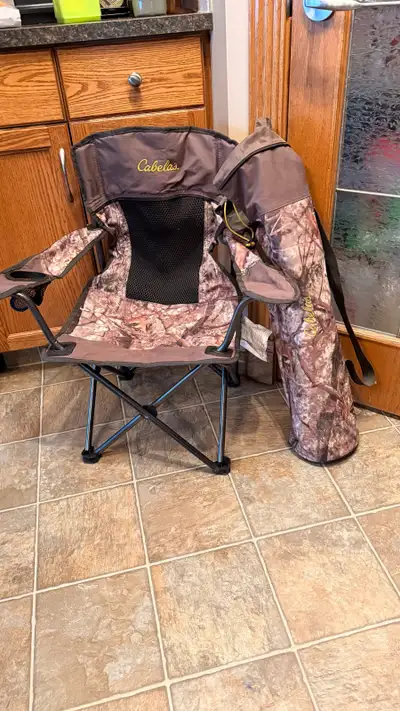 Durable Cabela's folding chair with Zonz Woodlands camouflage pattern and breathable black mesh back...
