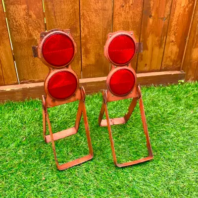 Vintage reflectors with folding metal stands, sold as a pair. Great for collectors, garage décor, wo...