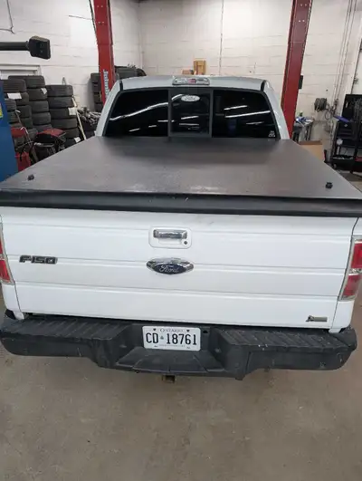 Undercover brand hard tonneau cover for 2009 -2014 with 5'6" bed in great shape lift struts and lock...