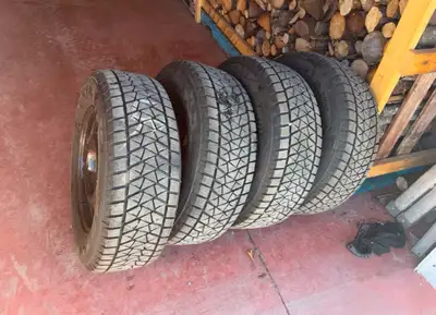 Set a four Bridgestone Blizzack Snow tires and steel rims with maybe a couple thousand kilometres on...