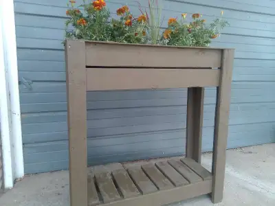 Homemade, wood plant stand 36inches wide 37 inches tall Comes with blood grass & marigolds