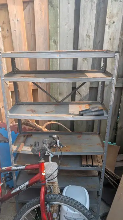 This sturdy, albeit somewhat weathered, metal shelving unit is ready to bring order to your garage,...