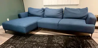 Large blue couch. Back cushions can move so that the couch can be shallow or deep. 108"long, 51" dee...