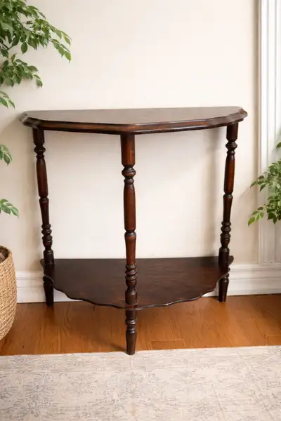 This is a used wooden hall table that offers a blend of classic style and practical utility for any...