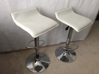 Pair of white swivel bar stools
