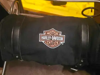 This pre-owned Harley-Davidson roll bag features a durable black canvas construction with elegant bl...
