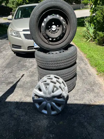 Used Firestone tires on rims , came off a 2005 Toyota Camry - hubcaps included as well - good tread...