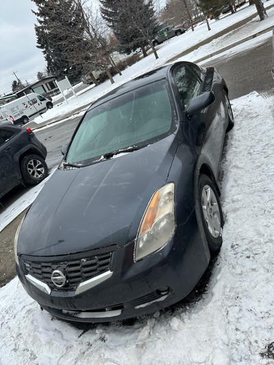 Nissan Altima 2.5s two door coupe with two sets of tires 