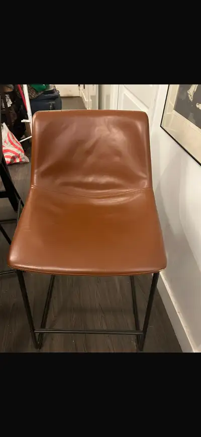 Selling two stylish light and dark brown leather bar stools. Both are in great condition and would l...