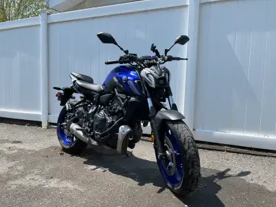 Blue Yamaha MT-07 with added slide guards, charger for phone with quad lock mount. 12,064 km usage....