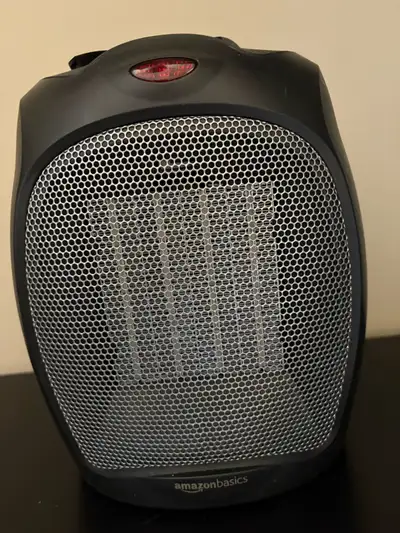 Stay cozy with this pre-owned AmazonBasics ceramic space heater, which is in good working condition...