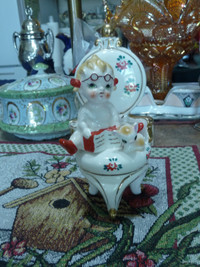 Cute Small Vintage Porcelain Figurine Of Baby On A Large Chair